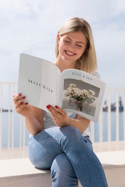 PSD woman on street reading book