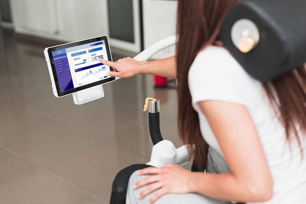 PSD woman using the digital tablet of a rehabilitation chair