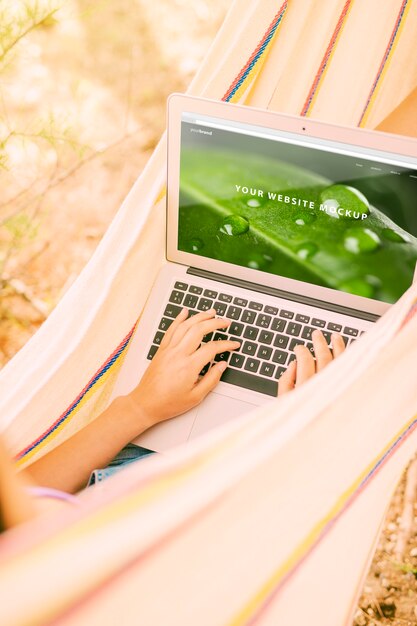 Woman using laptop mockup in nature