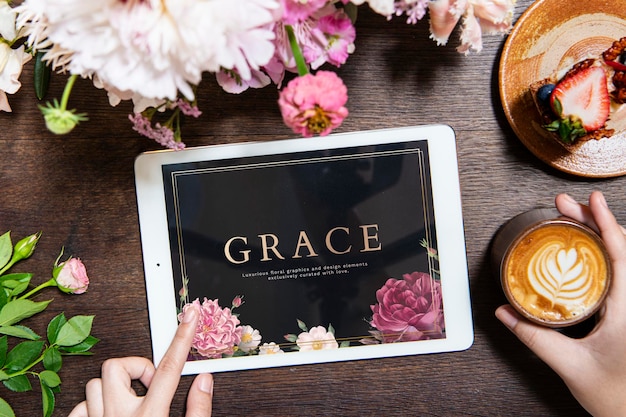 Woman using a laptop screen mockup in a cafe