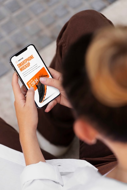 Woman using mock-up smartphone outdoors