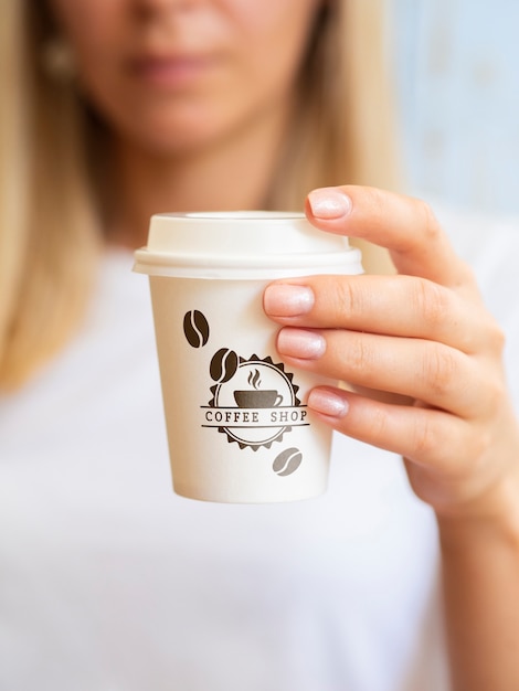 PSD woman wanting to drink from a coffee paper cup