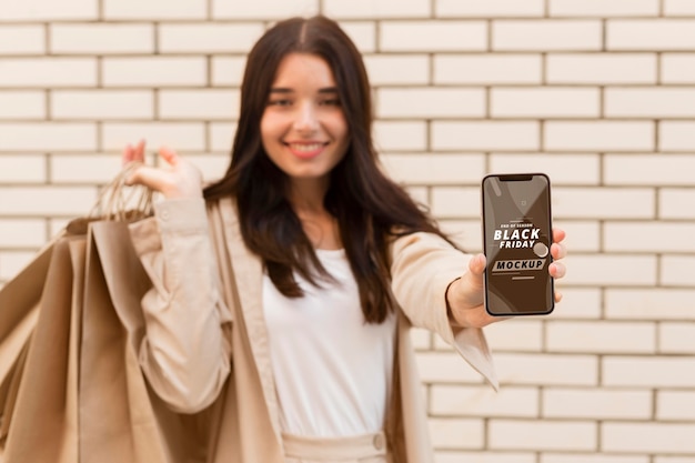 PSD woman with black friday smartphone mock-up