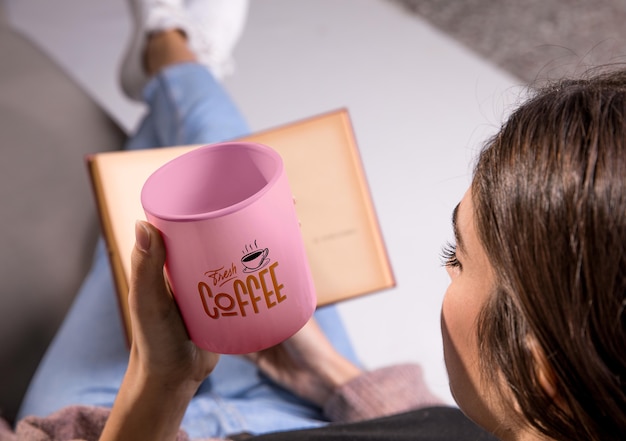 Woman with coffee mug reading