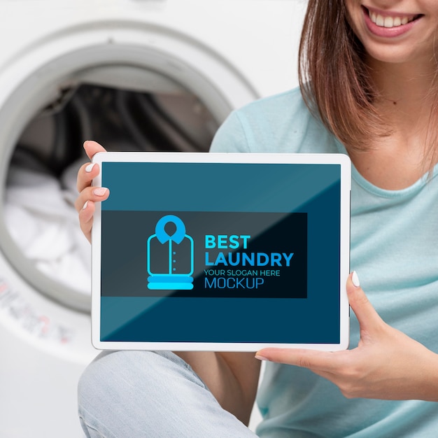 Woman with towel holding tablet mock-up