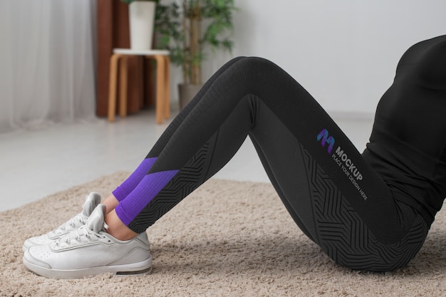 woman working out indoors while wearing leggings