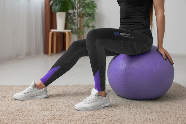 PSD woman working out indoors while wearing leggings