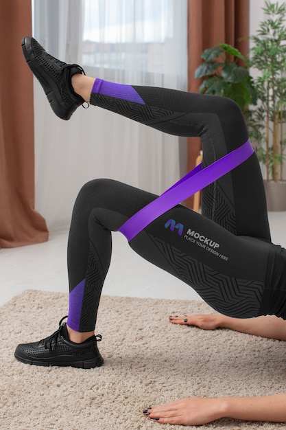 PSD woman working out indoors while wearing leggings