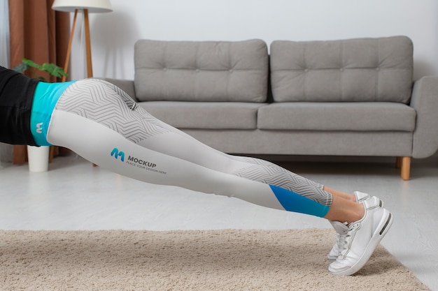 PSD woman working out indoors while wearing leggings