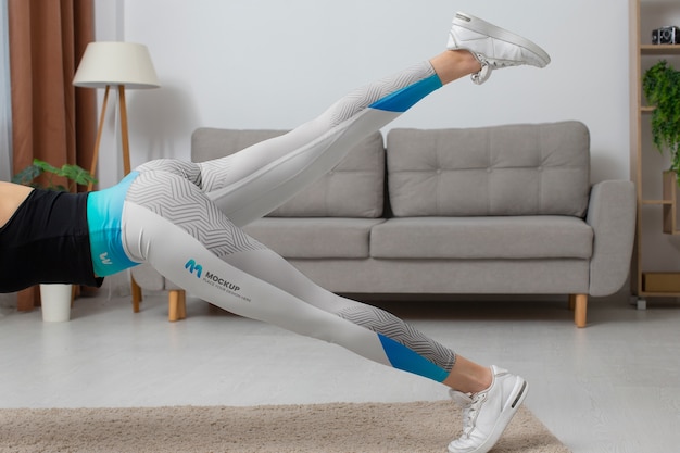 PSD woman working out indoors while wearing leggings