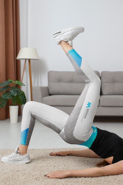 PSD woman working out indoors while wearing leggings