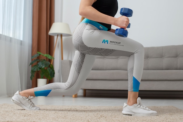 PSD woman working out indoors while wearing leggings