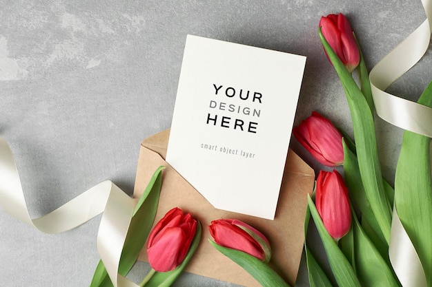 Womens day greeting card mockup with envelope and red tulip flowers