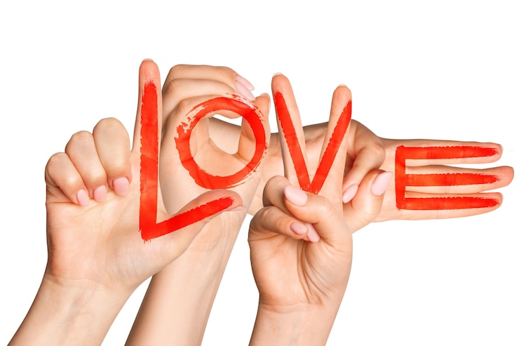 PSD womens hands folded into the word love red paint applied on a blank background