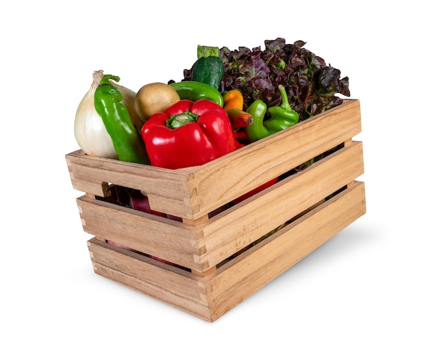 Wooden box full of fresh vegetables isolated from the background