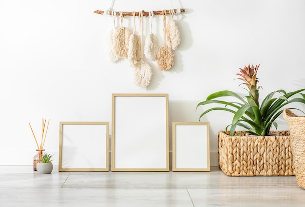 PSD wooden frame for photos and linen flowers branch in scandinavian interior mockup minimal template with empty picture blank plant and aroma sticks at home