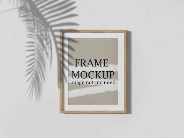 Wooden poster frame mockup with tree shadow falling on it