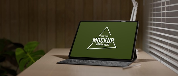 work space with graphic tablet with keyboard under light on wood table beside the window