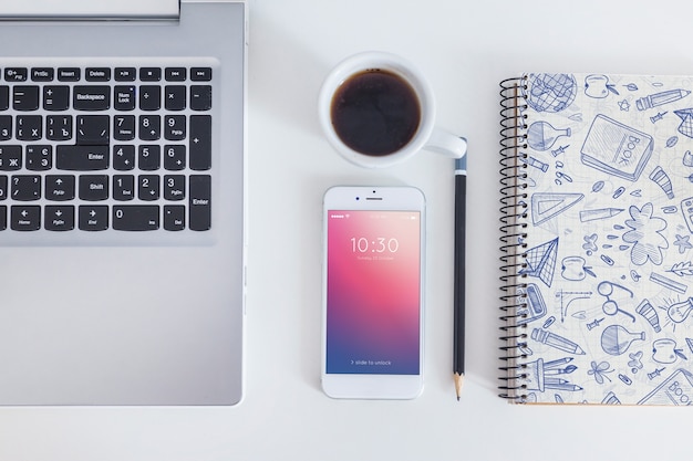 Workspace mockup with smartphone and laptop