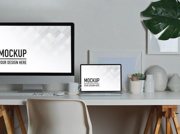 Workspace with laptop and desktop mockup, books and stationery