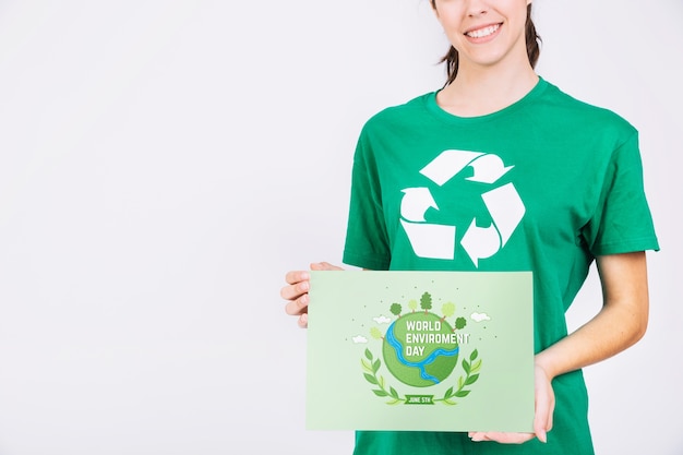 World environment day mockup with volunteer holding paper