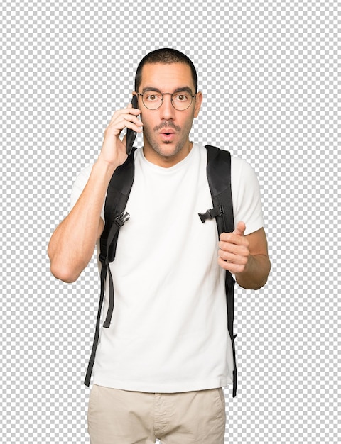 Worried student pointing up and using his mobile phone