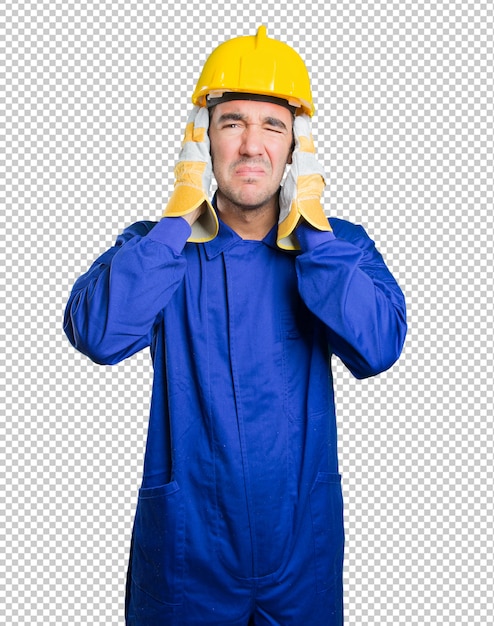 PSD worried workman covering his ears with his hands on white background