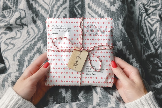 Wrapped parcel in woman hands mockup