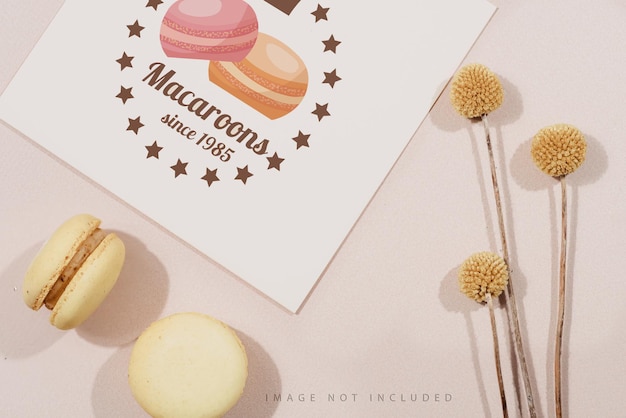 Yellow macarons with dry flowers and mockup letter on a beige background