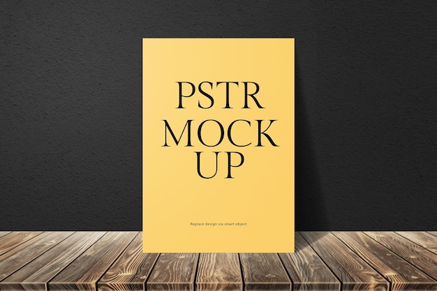 PSD yellow poster mockup on wood surface