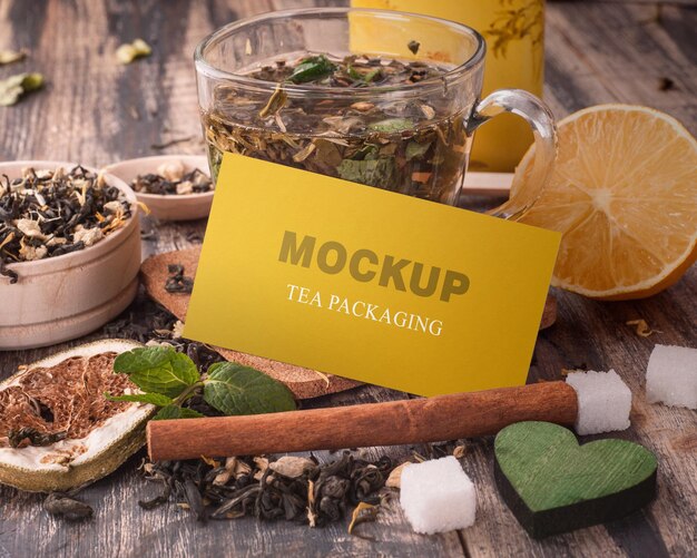 A yellow sign that says mock tea packaging on a wooden table mockup PSD