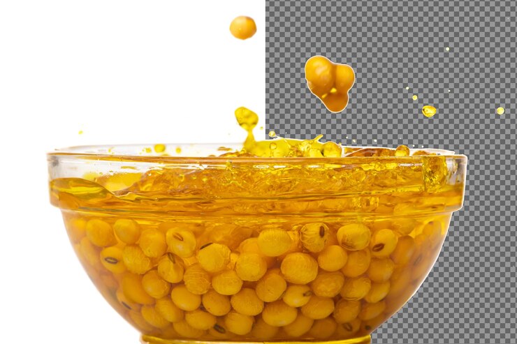 PSD yellow soy bean in vegetable oil pour fall down in air golden soybean mix with cooking oil pouring into bowl soy bean is healthy diet and food element cooking ingredients white background isolated