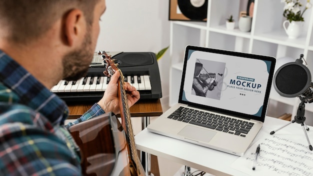 Young adult recording his music on device mockup