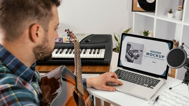 Young adult recording his music on device mockup