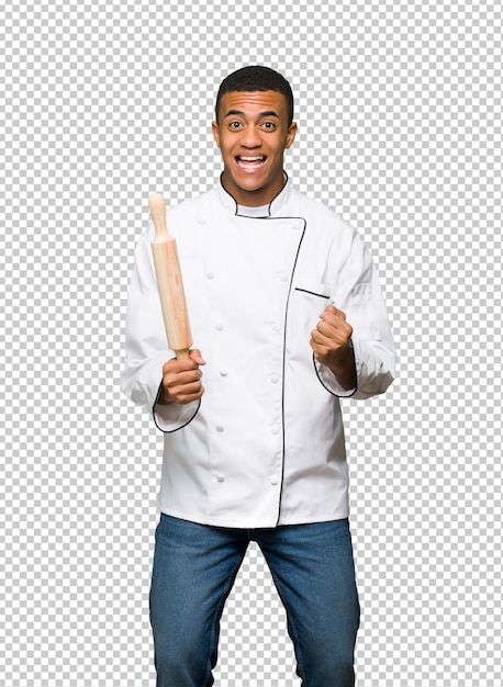 Young afro american chef man celebrating a victory in winner position