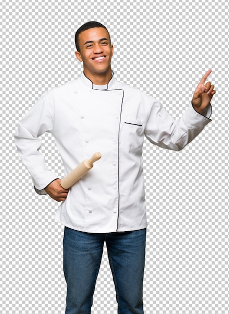 Young afro american chef man showing and lifting a finger in sign of the best