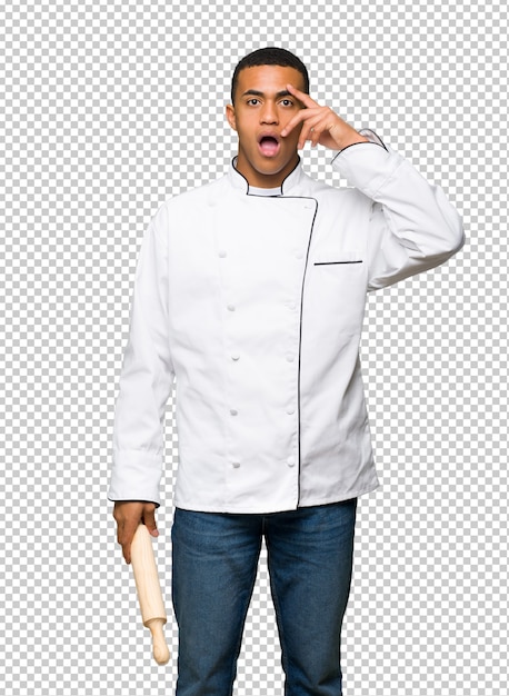 Young afro american chef man with surprise and shocked facial expression