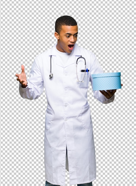 Young afro american man doctor holding gift box in hands