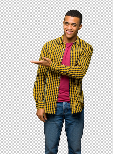 Young afro american man presenting an idea while looking smiling towards