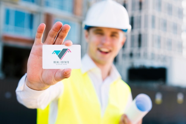 Young architect holding a business card