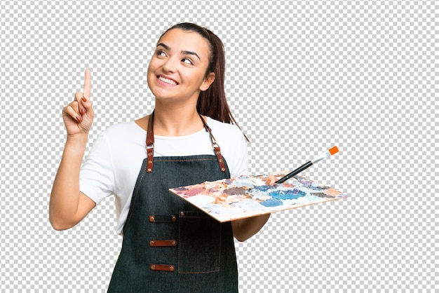 young artist woman holding a palette over isolated chroma key background pointing up a great idea