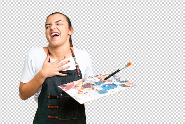 young artist woman holding a palette over isolated chroma key background smiling a lot