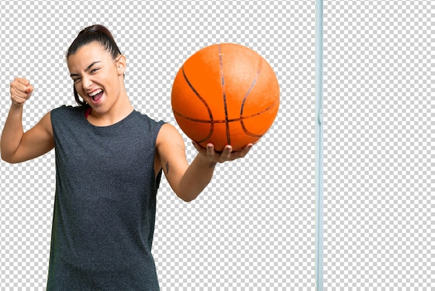 Young beauty woman over isolated chroma key background playing basketball