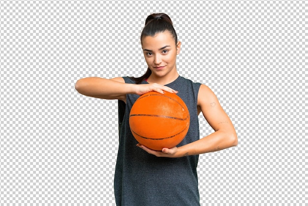 Young beauty woman over isolated chroma key background playing basketball