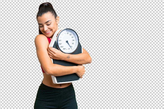 Young beauty woman over isolated chroma key background with weighing machine