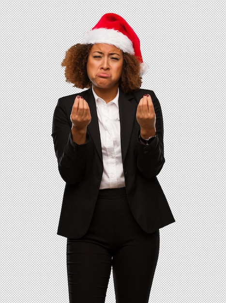 PSD young black businesswoman wearing a christmas santa hat doing a gesture of need