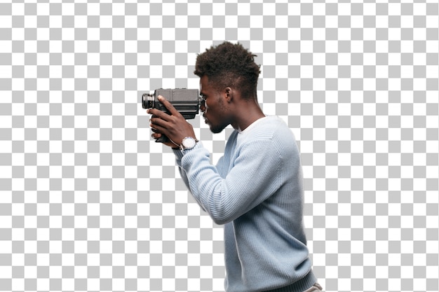 PSD young black man recording with a super 8 vintage cinema camera