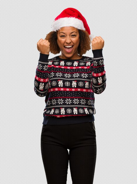 PSD young black woman in a trendy christmas sweater with print surprised and shocked