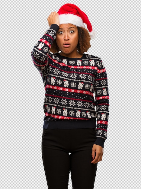 Young black woman in a trendy christmas sweater with print worried and overwhelmed