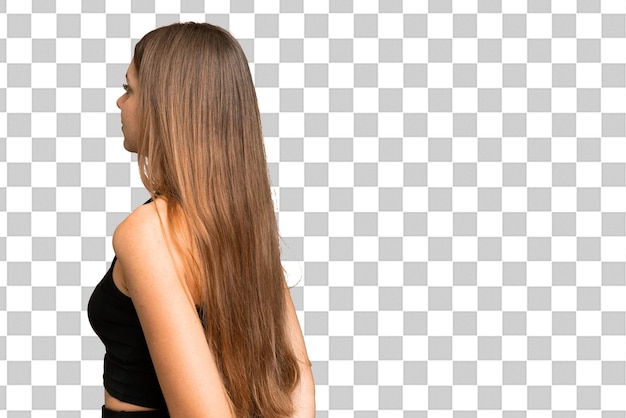 Young blonde woman over isolated chroma key background in back position and looking back